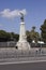 Angel statue in Nice, with two people walking near it