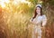 Angel woman in a grass field with sunlight