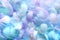 Angelic pastel tinted blue feather background - small fluffy blue feathers randomly scattered forming a background