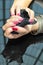 Anger Female hands with red nails wrapping black paper tissue