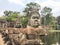 Angkor Wat Carved Statues By Water On Walkway Bridge