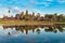 Angkor Wat sunny day blue sky main facade reflection on water pond sunset light. World famous temple in Cambodia, tourist travel