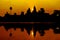 Angkor Wat at sunrise across the lake, reflected in water