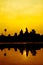 Angkor Wat at sunrise across the lake, reflected in water