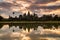 Angkor Wat temple at dramatic sunrise reflecting in water