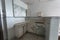 Angle view of cabinets and peeling paint in an abandoned hospital