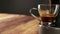 Angle view of close up of italian espresso coffee. A woman`s hand rests the glass cup under the jets of the machine, the coffee fi