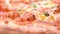 Angle view fresh pizza with shrimps and bacon toppings turning close up