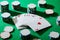 Angle view of pack of cards with casino chips on green