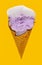 angle view of sweet potato flavor ice cream cone with frozen top with a bite on yellow background