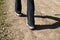 Angled close up of woman\'s feet hiking in black pants