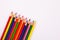 Angled coloring art pencils lined up on solid white background