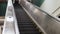 Angled shot of escalator going down in underground subway station