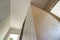 Angled view of new unfinished apartment under reconstruction. White ceiling, plastered walls, doors openings. Construction and