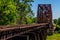 Angled View of a Train Track and Old Iconic Truss Bridge.