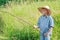 Angler concentrated boy watching after handmade fishing rod float on water