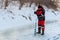 The angler drills a hole in the ice for ice fishing