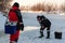 The angler drills a hole in the ice for ice fishing