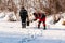 The angler drills a hole in the ice for ice fishing