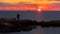 An angler fishes in the Mediterranean on the rocky coast at Torrevieja in the morning at sunrise.