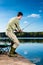 Angler fishing at lake standing on jetty