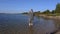 Angler with fishing rod in water