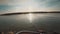 An angler spinning predatory fish from a boat on the beautiful river at sunset