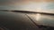 Angler spinning predatory fish from a boat on the river at amazing sunset