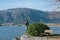 Angler statue on the shores of Lake Ceresio in Bissone near Lugano: Canton Ticino. Switzerland- January, 2020