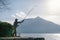 Angler statue on the shores of Lake Ceresio in Bissone near Lugano: Canton Ticino. Switzerland- January, 2020