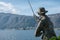 Angler statue on the shores of Lake Ceresio in Bissone near Lugano: Canton Ticino. Switzerland- January, 2020