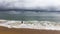 Angler on Taquaras beach with a stormy sky, Brazil