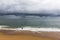 Angler on Taquaras beach with a stormy sky, Brazil