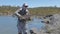 An angler and trout in tasmania`s western lakes