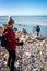 An angler in waders is fishing on the Baltic Sea coast in MiÄ™dzyzdroje