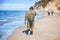 An angler in waders is fishing on the Baltic Sea coast in MiÄ™dzyzdroje