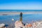 An angler in waders is fishing on the Baltic Sea coast in MiÄ™dzyzdroje