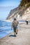 An angler in waders is fishing on the Baltic Sea coast in MiÄ™dzyzdroje