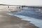 Angler and walkers upon beach in Nes, Ameland, Holland