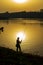 Anglers in romantic mood on the banks of a river at sunset