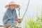 Angling teenage boy with handmade green twig fishing rod