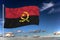Angola national flag waving in the wind against deep blue sky.  International relations concept