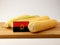 Angolan flag on a wooden panel with corn isolated on a white bac