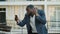 Angry african businessman video chatting outside. Business man calling phone