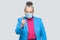 Angry aged woman with surgical medical mask warning you