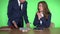 Angry boss man in suit shouting at female employee sitting at desk in office