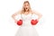 Angry bride in a wedding dress and boxing gloves