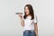 Angry brunette girl shouting mad while recording voice message, being outraged, white background