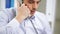 Angry businessman calling on phone at office