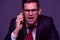Angry businessman furiously talking on the phone